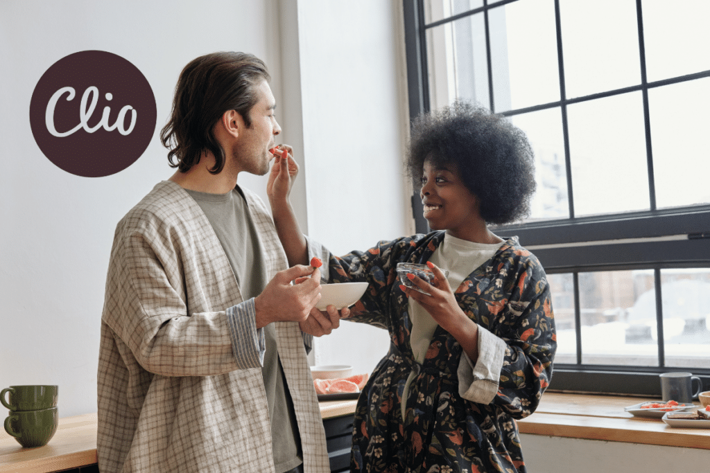 A woman feeding a man snacks