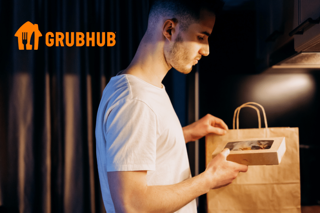 A man grabbing food from a paper bag